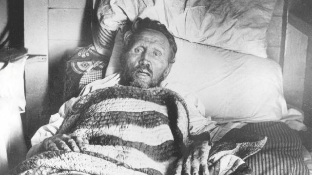 Father Damien on his deathbed. Credits.