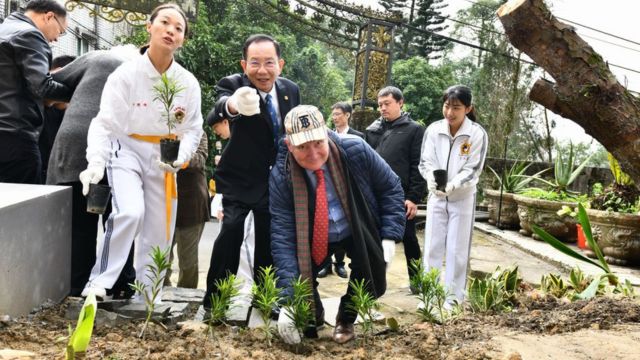 Massimo Introvigne planting a tree at the Swiss Mountain Villa site, with Dr. Hong Tao-Tze.
