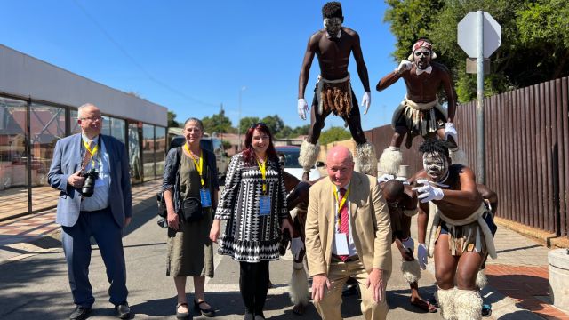The author, Peter Zoehrer (left), with traditional performers when visiting in January 2023 the historical Mandela House in Soweto, where Mandela lived since 1946, with (from left to right) scholars Holly Folk, Karolina Maria Kotkowska, and Massimo Introvigne.