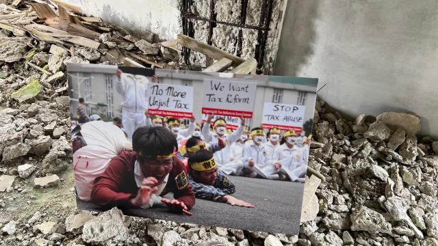 A Tai Ji Men protest sign among the debris of the Swiss Mountain Villa.